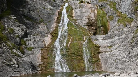 A mossy waterfall with a pond in the middle Stock Footage 260846100