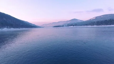 Most beautiful river in the winter. Snow-covered trees on the river bank. Aerial Stock Footage 73008000