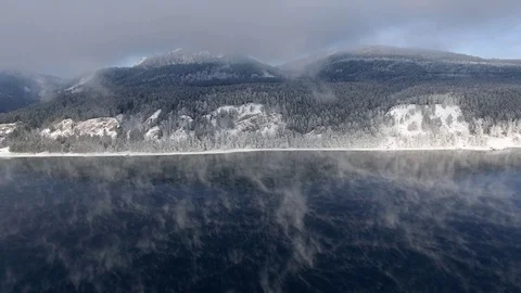 Most beautiful river in the winter. Snow-covered trees on the river bank. Aerial Stock Footage 73008686