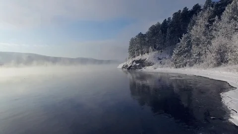 Most beautiful river in the winter. Snow-covered trees on the river bank. Aerial Video stock 73071225