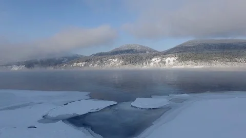 Most beautiful river in the winter. Snow-covered trees on the river bank. Aerial Video stock 73071226