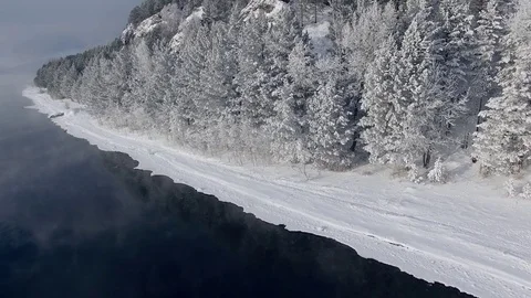 Most beautiful river in the winter. Snow-covered trees on the river bank. Aerial Video stock 73071313