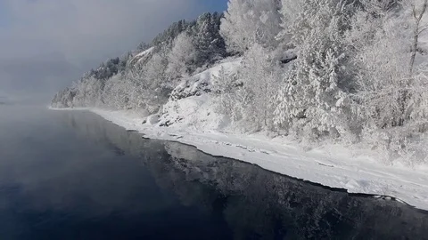 Most beautiful river in the winter. Snow-covered trees on the river bank. Aerial Stock Footage 73071504
