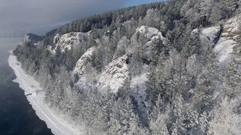 Most beautiful river in the winter. Snow-covered trees on the river bank. Aerial Video stock 73071513
