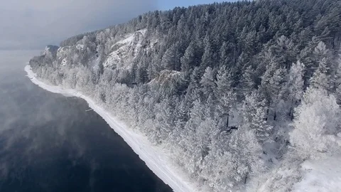 Most beautiful river in the winter. Snow-covered trees on the river bank. Aerial Video stock 73071530