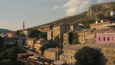 Mostar Cityscape at Riverside During Sunset, View From Bridge, Bosnia, Pan Stock Footage 220566167