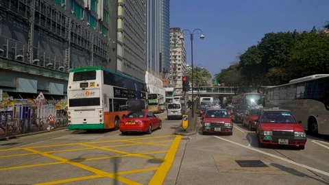Mostly cabs crossing a road in downtown Hongkong Stock Footage 90497251