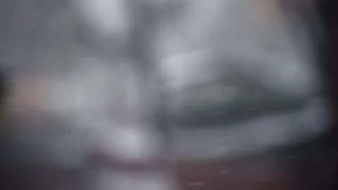 Mostly out of focus shot with small snow flakes flying by Stock Footage 268621583