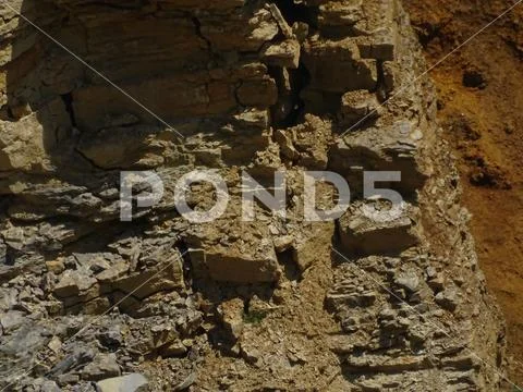 Mostly red sedimentary rock spotted in limestone quarry ~ Hi Res #117597648
