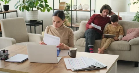 Mother analyzing documents and father helping son with homework on digital Stock Footage 145226606