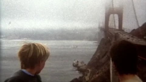 Mother and 2 sons looking out across Golden Gate Bridge and harbor on foggy Stock Footage 194515544