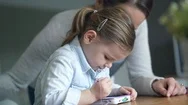 Mother And Adorable Young Daughter Playing Games On Kids Tablet At Home Stock Footage