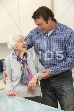 Mother and adult son in kitchen Stock Photos