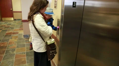 Mother and baby getting on elevator Stock Footage 32862579