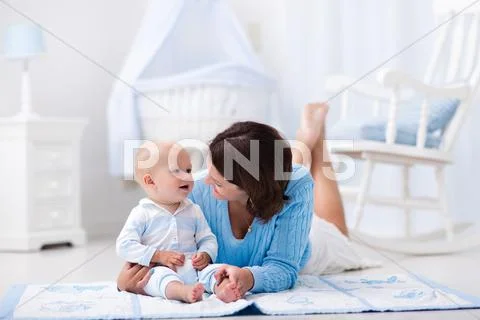 Mother and baby playing on the floor Stock Photos