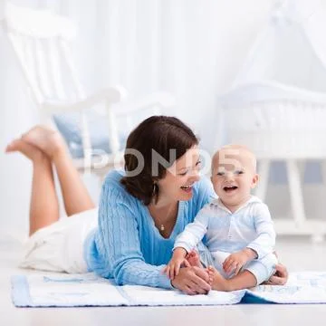 Mother and baby playing on the floor Stock Photos