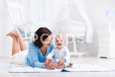 Mother and baby playing on the floor Stock Photos