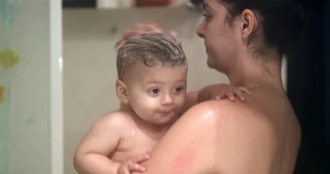 Mother and baby in shower together. Mom ... | Stock Video