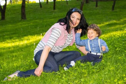 Mother and boy having fun in grass 스톡 사진