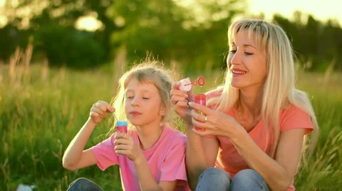 Mother and the child blowing bubbles. Slow motion Stock Footage 66065862