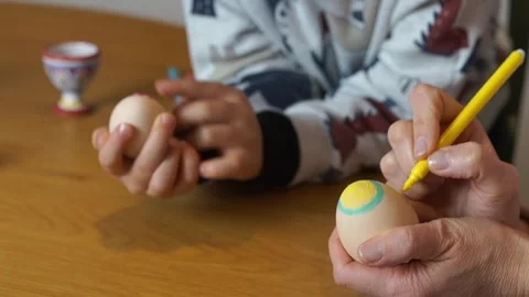 Mother and Child Decorating Easter Eggs with Felt Pens Stock Footage 329248198
