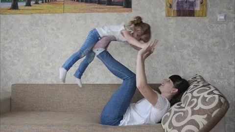 Mother and child having fun on a coach Stock Footage 152287786
