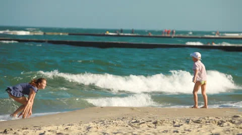 Mother and child playing on the beach Stock Footage 24129232