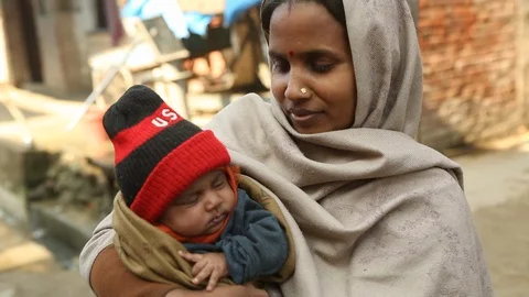 Mother and child together in rural winter India villageStock Footage