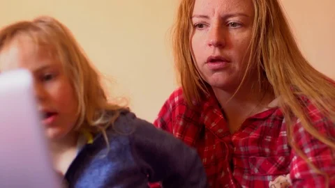 Mother and child using tablet in bed before going to sleep Stock Footage 73547096