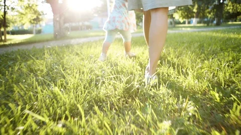 Mother and child walking on the grass Stock-Footage 77089448