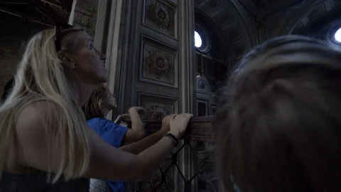 Mother and children looking up at ceiling of dark cathedral Stock Footage 103184982