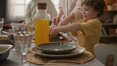 Mother and Children Setting Table and Holding Hands before Dinner Stock Footage 340333178