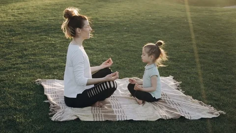 Mother and daugher are practising yoga. Family time. Family values. Video stock 89967412