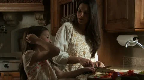 Mother and daughter cooking in kitchen Stock Footage