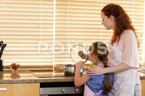 Mother and daughter cooking a meal Stock Photos
