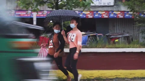 Mother and Daughter crossing the street wearing surgical mask Stock Footage