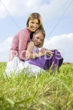 Mother and daughter, crouching Stock Photos