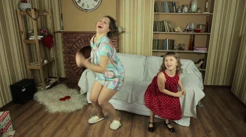 Mother and daughter dancing and having fun in the living room. Stock Footage 60793853