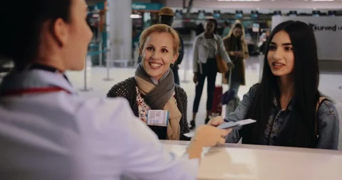 Mother and daughter doing check-in at airport before travel Stock Footage