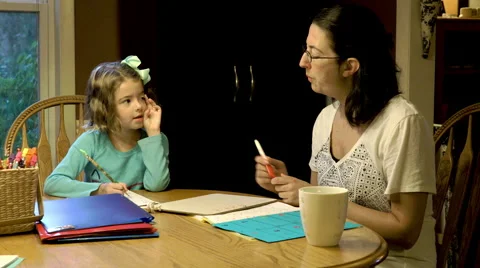 Mother and daughter doing homeschool together Stock Footage