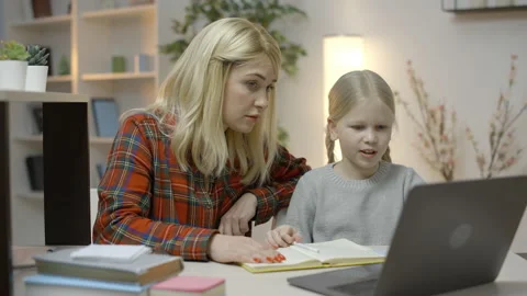 Mother and daughter doing homework  together, working on problem solution Stock Footage 149259141