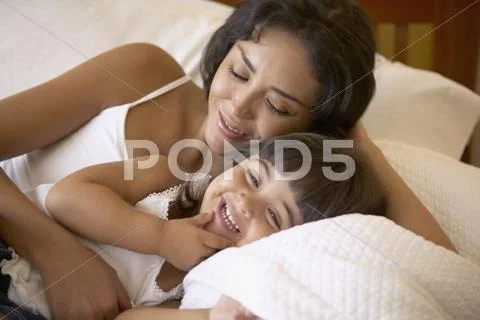 Mother and daughter giggling together Stock Photos