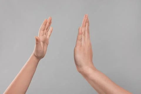 Mother and daughter giving high five on light grey background, closeup of han Stock Photos