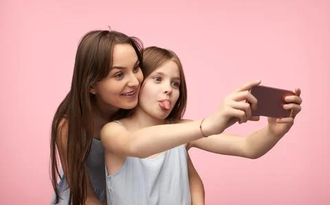 Mother and daughter grimacing for selfie Stock Photos