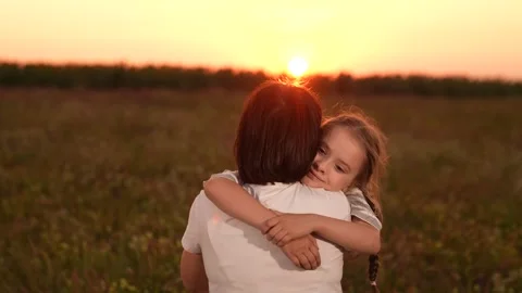 Mother and daughter hug at sunset, Family love in the evening sun, Warm embrace Stock-Footage 311431153