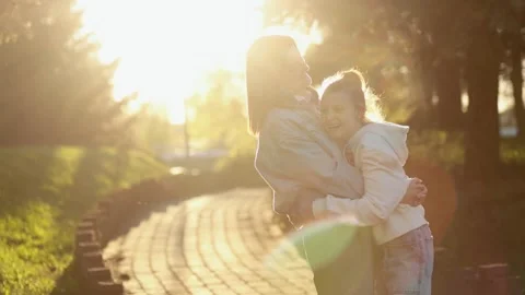 Mother and daughter hugging while walking in the park. Stock Footage 164900477