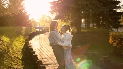 Mother and daughter hugging while walking in the park. Stock Footage 164900908