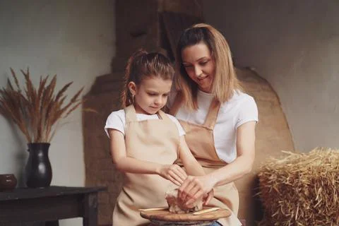 Mother and daughter mold with clay, enjoying pottery art and pro Stock Photos
