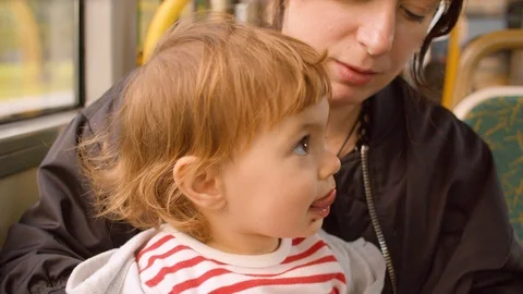 Mother and daughter in a moving bus Video stock 114687853