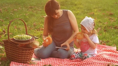 Mother and daughter on a picnic at sunset Stock Footage